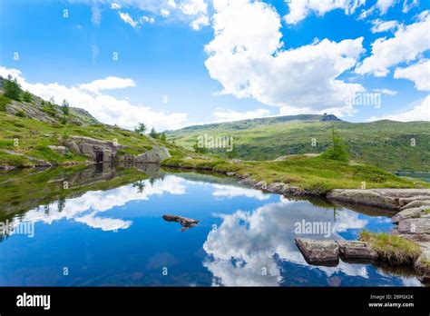 Italian Mountain Panorama Clouds Reflected On Alpine Lake Trekking