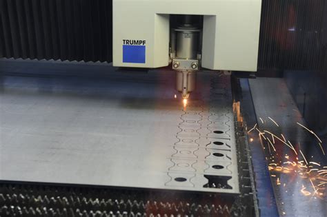 1 A Metal Sheet Is Being Cut Inside A Cnc Laser Cutting Machine