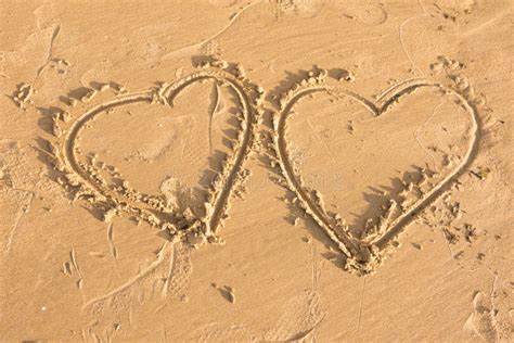 Two Hearts Drawn In The Sand On Sea Beach Stock Image Image Of