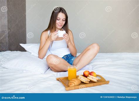 Beautiful Brunette Girl Eating A Healthy Breakfast And Drinking Coffee