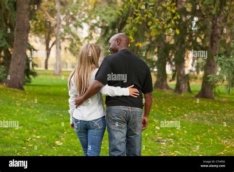 Interracial Married Couple Walking In A Park In Autumn Edmonton