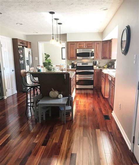 Small kitchen with black cabinets. Cherry wood kitchen cabinets with features like detailed ...