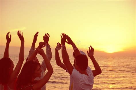 Group Of Happy Young People Dancing At The Beach On Beautiful Summer