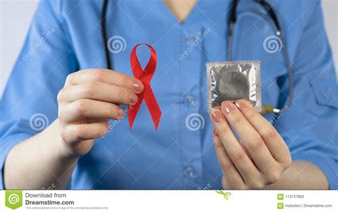 Doctor Holding Red Ribbon Condom Sexually Transmitted Diseases Warning