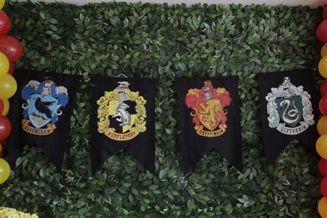 There Are Three Harry Potter Flags Hanging On The Wall In Front Of