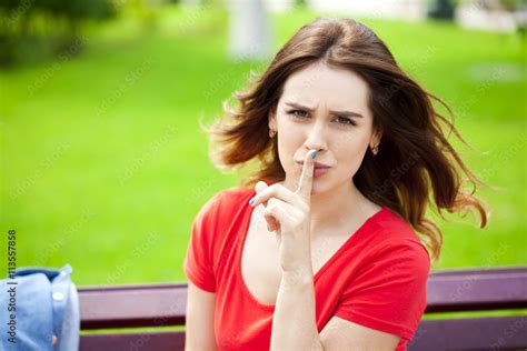 Young Beautiful Brunette Woman Has Put Forefinger To Lips As Sig Stock