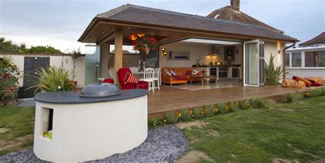 An Outdoor Living Area With Patio Furniture And Wooden Decking