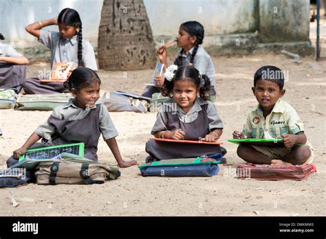 Rural Indian Village School Children In An Outside Class Writing On A