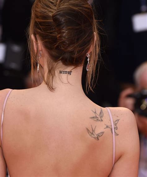 Dakota Johnson Has The Word “amor” Tattooed On The Back Of Her Neck In Black Ink Dakota