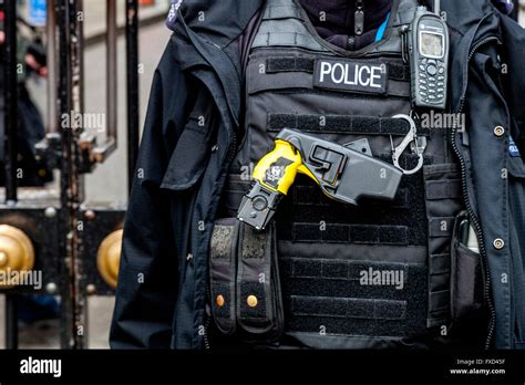 British Police Officer With Taser Gun London England Stock Photo
