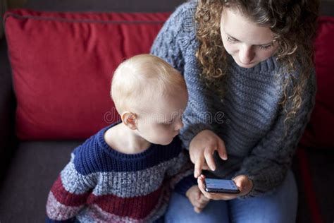 Mom Shows Her Little Son How To Use A Mobile Phone Stock Photo Image