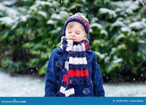 Cute Little Funny Child In Colorful Winter Fashion Clothes Having Fun