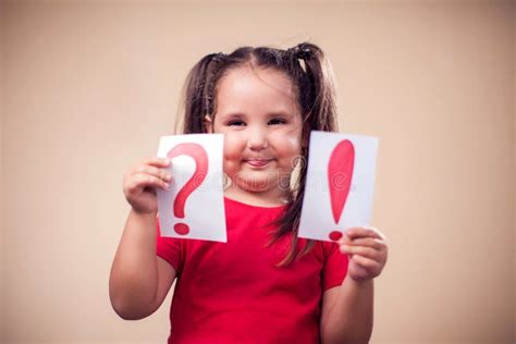 A Portrait Of Kid Girl Holding Cards With Exclamation Point And