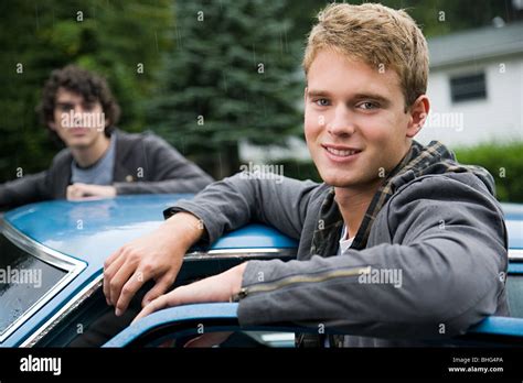 Two Young Men By Car Stock Photo Alamy
