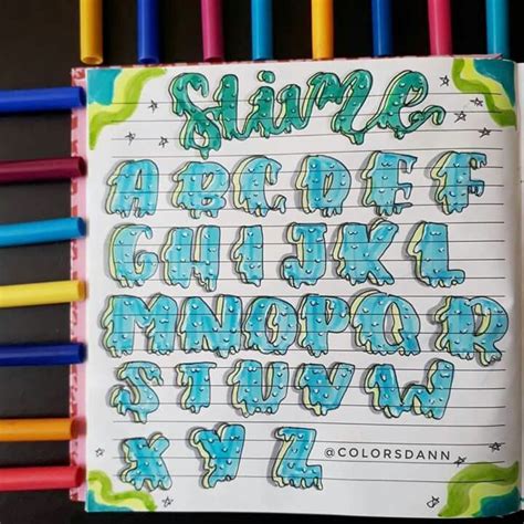 An Open Notebook With Writing On It And Colored Pencils In Front Of The