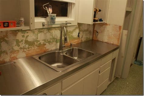 Before you lay the granite slabs back on top, lay down some cardboard to protect the sink overnight. Remodelaholic | Affordable Stainless Steel Countertops; DIY