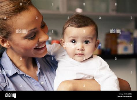 Mother Holding Baby Girl Stock Photo Alamy