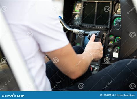 Portrait Of Commercial Pilot In Uniform Sitting Inside Helicopter Cabin
