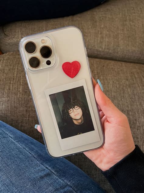 A Person Holding Up An Iphone Case With A Heart On The Back And A Photo