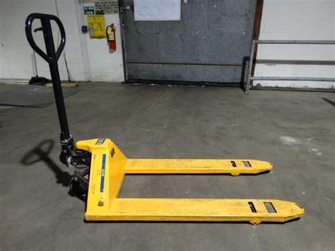 A pin holds the lower lever in place. Used Uline H-1043 5500 Pound Capacity Pallet Jack