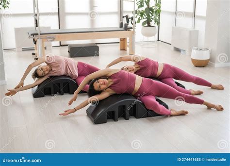 Balanced Body Pilates Arc Three Asian Women Exercising On Pilates Arc