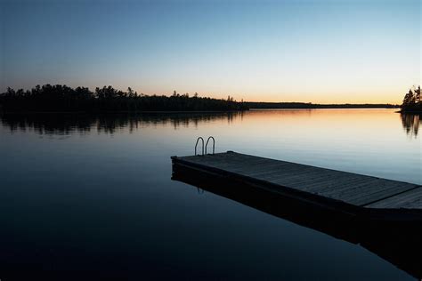 Sunset Over A Lake With A Wooden Dock Photograph By Keith Levit