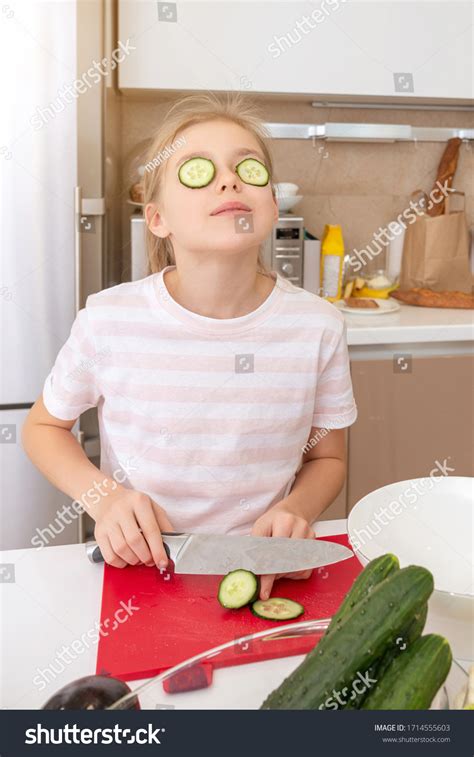 Preteen Girl Cutting Cucumber Knife On Stock Photo 1714555603