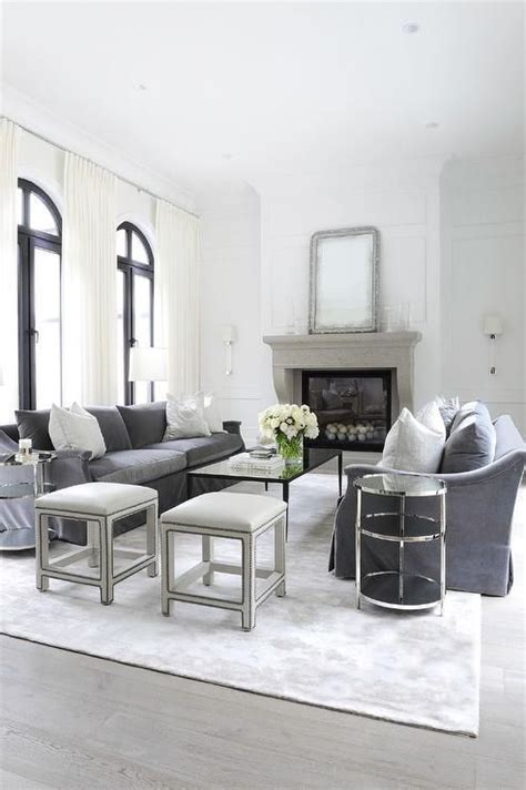 The belville sectional sofa features reversible chaise, two accent pillows, removable seat cushion, loose backrest pillows, and matching storage ottoman. Dark gray velvet sofas accented with silver damask pillows flanks a black coffee table positi ...