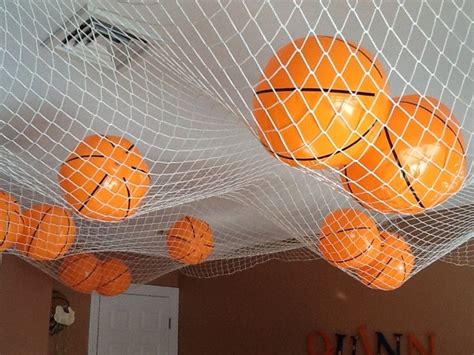 Several Oranges Are Suspended In A Net With Basketballs Hanging From