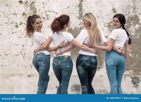 Group Of Diverse Girls In Tshirts And Jeans Over Street Wall Stock