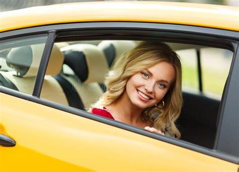 Photo Of Young Blonde Sitting In Back Seat Of Yellow Taxi Stock Image