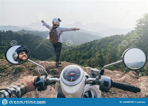 Caucasian Couple Riding Motorcycle In Laotian Mountains. Woman Stands ...