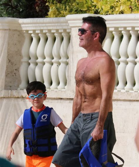 simon cowell looks slimmer than ever as he goes topless in barbados with son eric hell of a read