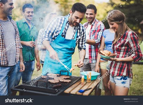 Friends Having A Barbecue Party In Nature While Having A Blast Barbecue