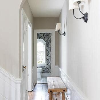 The walls of these narrow passages benefit from wainscoting's scuff and mark protection. Wainscoting Design Ideas