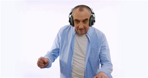The Old Man In Headphones Listening To Music Dancing Smiling