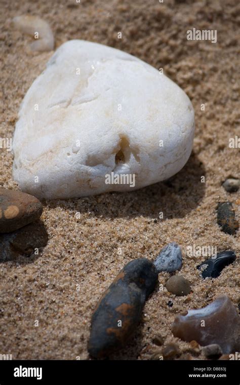 White And Black Stones On A Sandy Pebble Beach Stock Photo Alamy