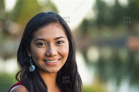Portrait Of A Beautiful Young Filipino Woman Smiling In A City Park In