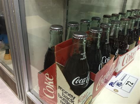 8 Pack Of Silver Capped Coca Cola Bottles And 6 Pack Of Coke Silver