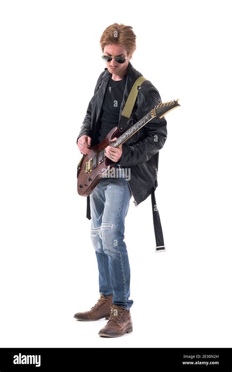 Side View Of Rock Musician Playing Electric Guitar In Stylish Clothes