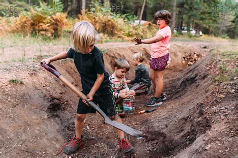 Kids Digging In A Ditch In Forest Stock Photo Offset