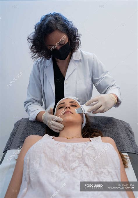 Professional Cosmetologist Doing Ultrasonic Face Peeling For Relaxed