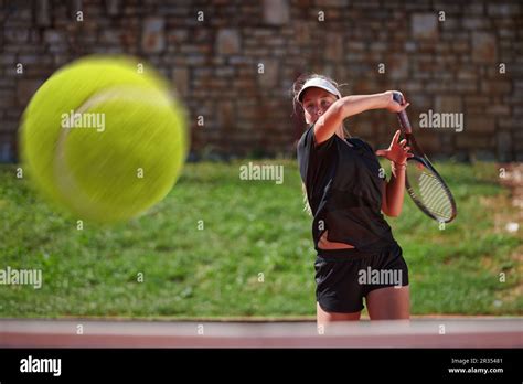 A professional female tennis player serves the tennis ball on the court