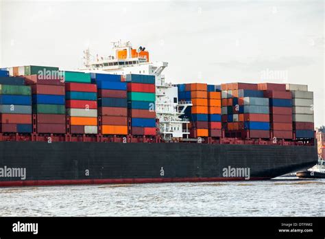 Fully Laden Container Ship In Port With Its Decks Stacked With Metal