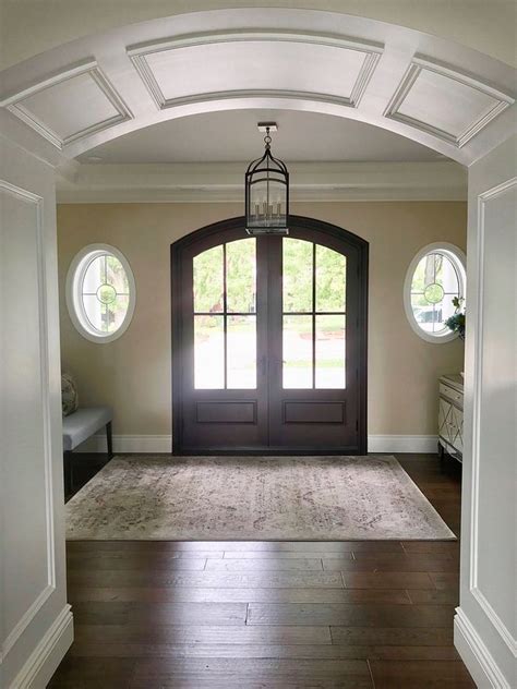 Double Door Foyer With Oval Windows Flanking Front Door Front Door