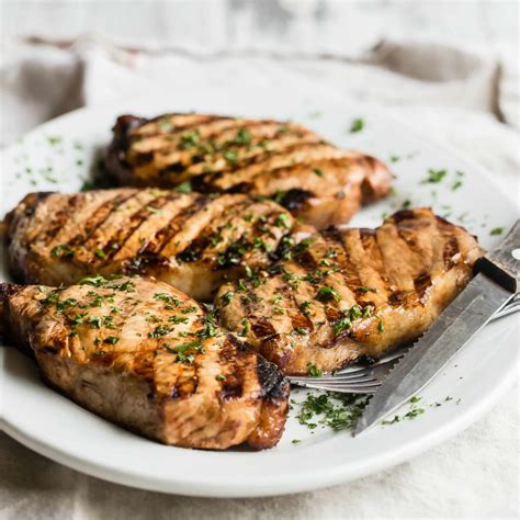 Sprinkle each pork chop, both sides, with salt, black pepper, garlic powder and rosemary. Grilled Pork Chops Recipe | Culinary Hill