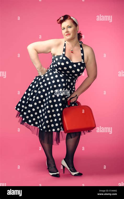 Mature Pin Up Woman Wearing 50s Style Dress Pink Background Stock
