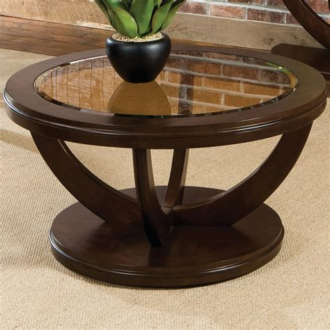 This round shape coffee table is made from mango wood and features a smooth wide top that can be used for serving and various decorative purposes. Round Cocktail Table with Glass Top by Standard Furniture ...