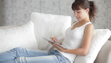 Cheerful Babe Woman Sitting On Sofa Reading Book And Smiling At Camera Stock Footage Video