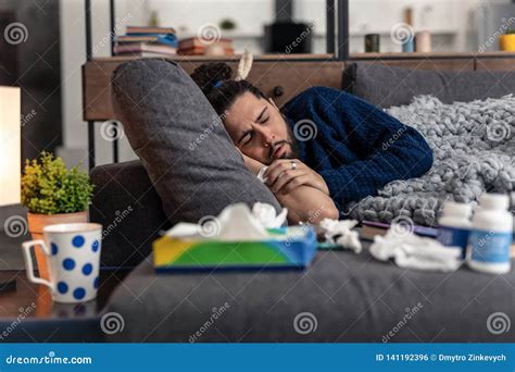 Unhappy Tired Man Falling Asleep On The Sofa Stock Photo Image Of